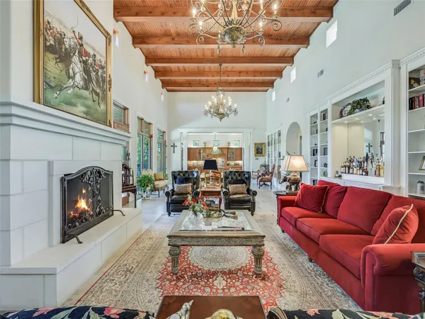 a living room with furniture fireplace and a large window