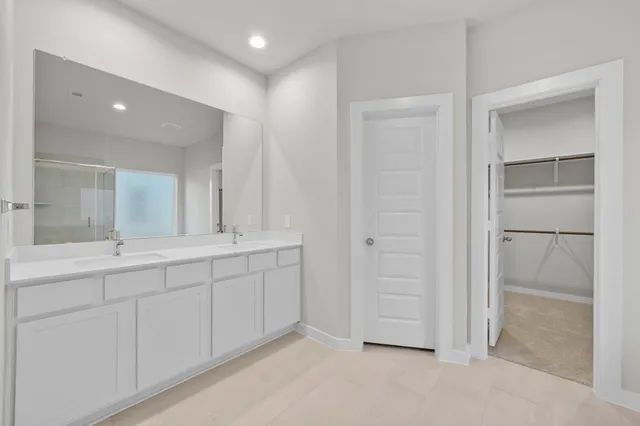 a bathroom with a double vanity sink and a mirror