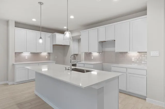 a kitchen with kitchen island a sink stainless steel appliances and cabinets