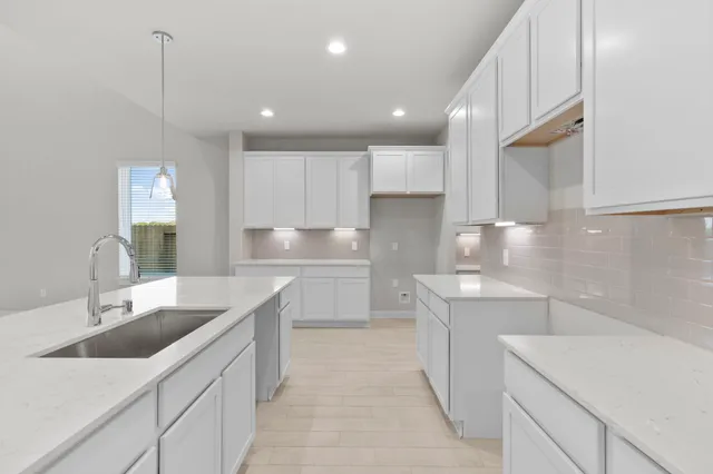 a kitchen with a sink stove and cabinets