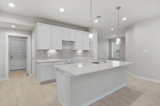 a large kitchen with kitchen island a sink stainless steel appliances and cabinets