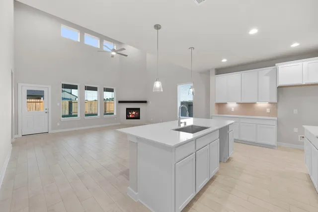 a kitchen with a sink cabinets and window