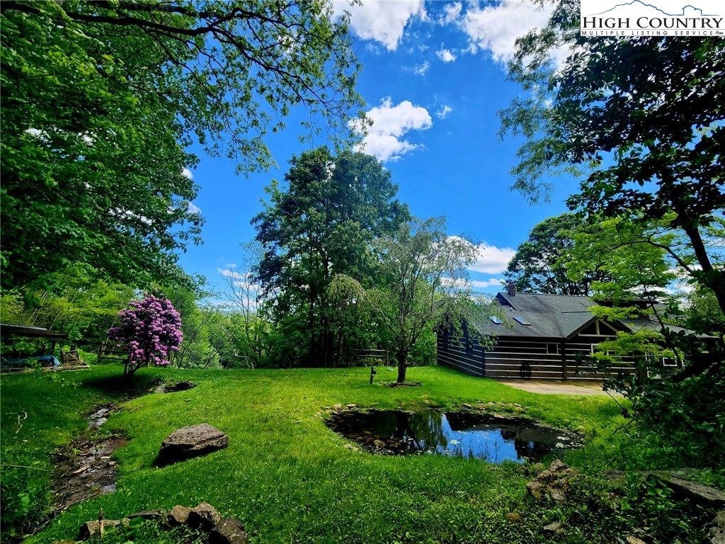 690-692 Lynn Hill Road Vilas, NC 28692 - Photo 15 of 50 a view of a garden with a fountain