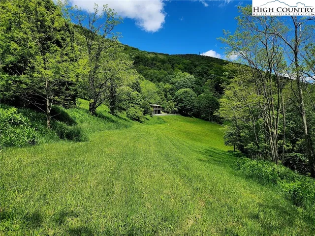 a kitchen with a table chairs a stove and a window