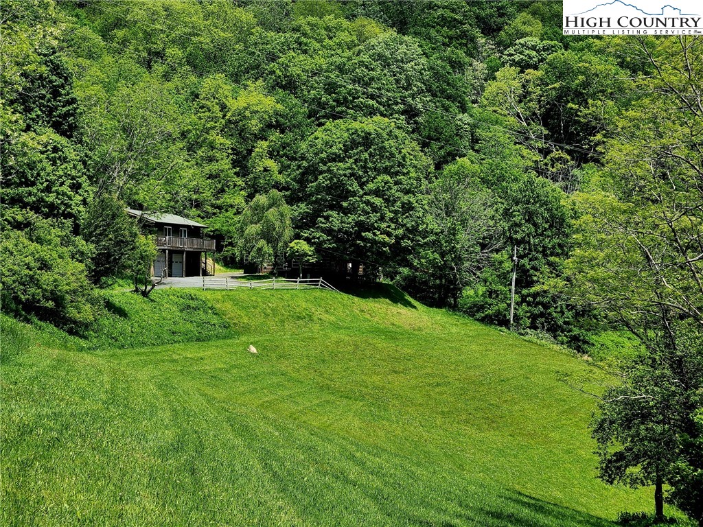 690-692 Lynn Hill Road Vilas, NC 28692 - Photo 17 of 50 a view of a house with a backyard