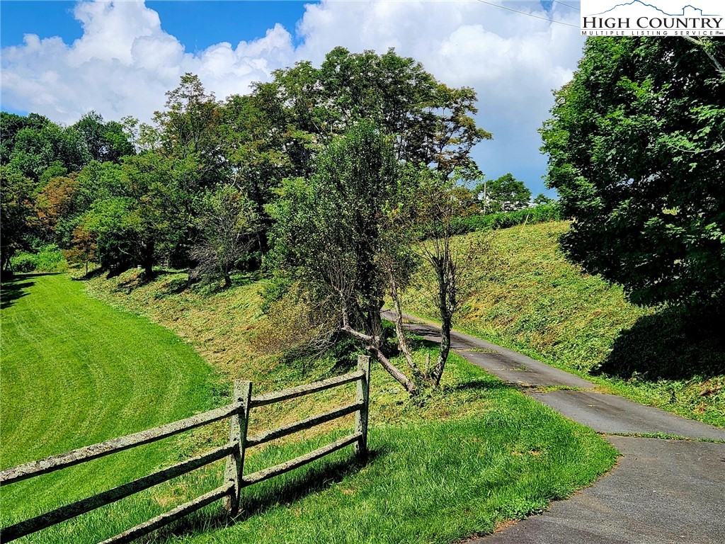 690-692 Lynn Hill Road Vilas, NC 28692 - Photo 19 of 50 a view of a garden with a bench in the garden