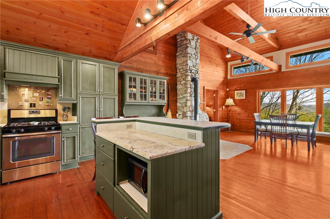 690-692 Lynn Hill Road Vilas, NC 28692 - Photo 24 of 50 a kitchen with stainless steel appliances granite countertop a stove and a wooden floors