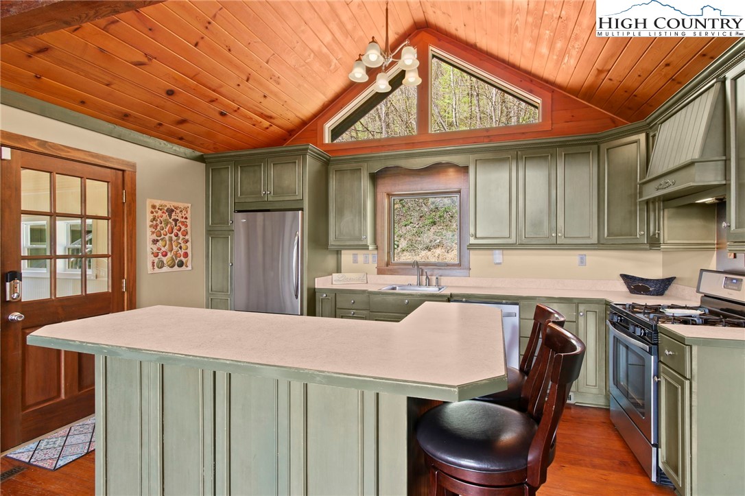 690-692 Lynn Hill Road Vilas, NC 28692 - Photo 26 of 50 a kitchen with a table chairs a stove and a window