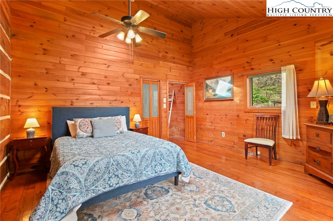 690-692 Lynn Hill Road Vilas, NC 28692 - Photo 37 of 50 a bedroom with a bed and wooden floor