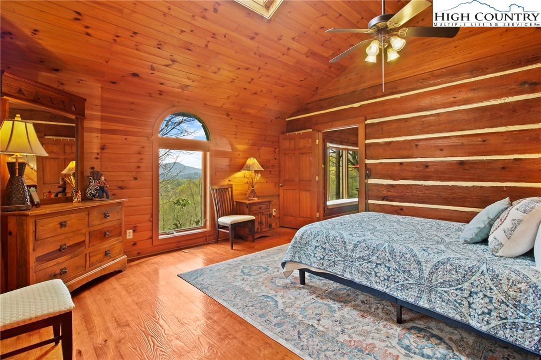 690-692 Lynn Hill Road Vilas, NC 28692 - Photo 39 of 50 a bedroom with a bed and a dresser next to a window