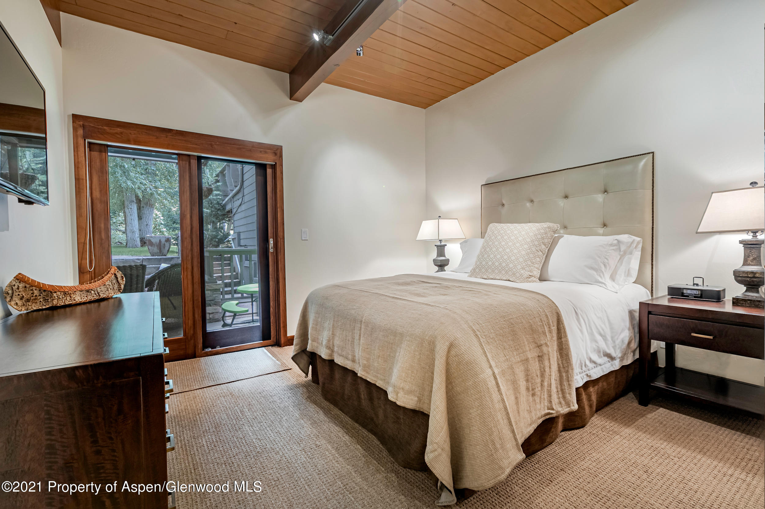 851 Ute Avenue, Unit A Aspen, CO 81611 - Photo 11 of 20 a spacious bedroom with a bed and glass door