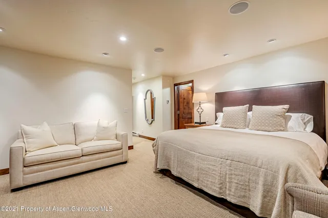 a spacious bedroom with a bed and a couch