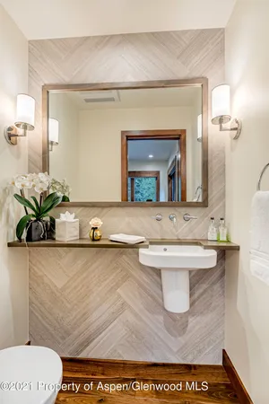 a bathroom with a toilet a sink and a mirror