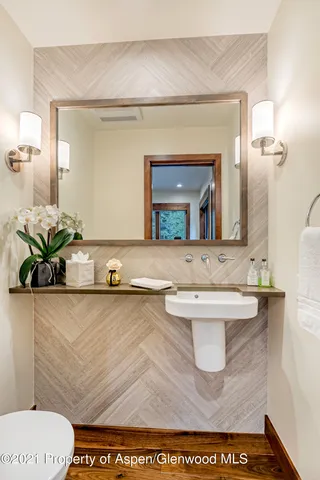 a bathroom with a toilet a sink and a mirror