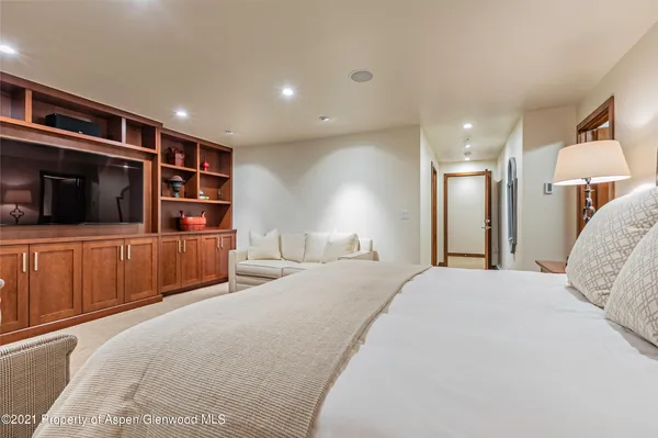 a bedroom with a bed and a television