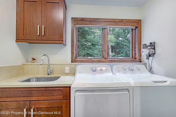 a utility room with sink dryer and washer
