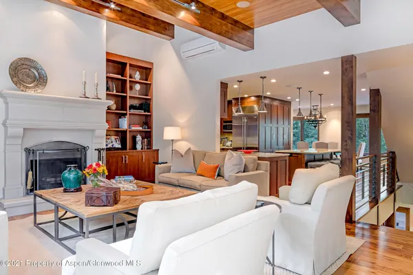 a living room with furniture a fireplace and a large window