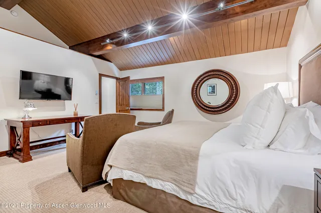 a bedroom with a bed and a television