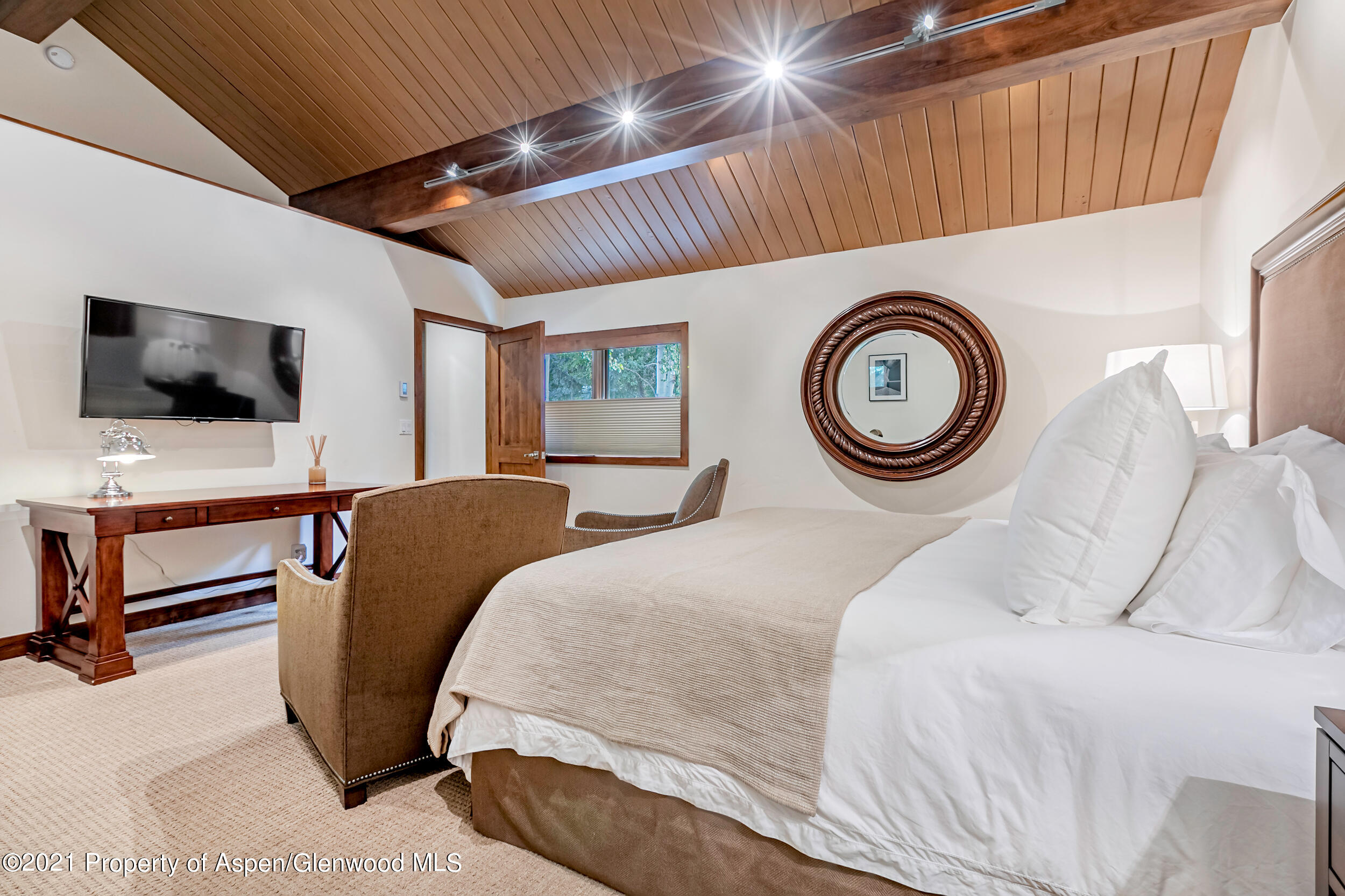 851 Ute Avenue, Unit A Aspen, CO 81611 - Photo 7 of 20 a bedroom with a bed and a television