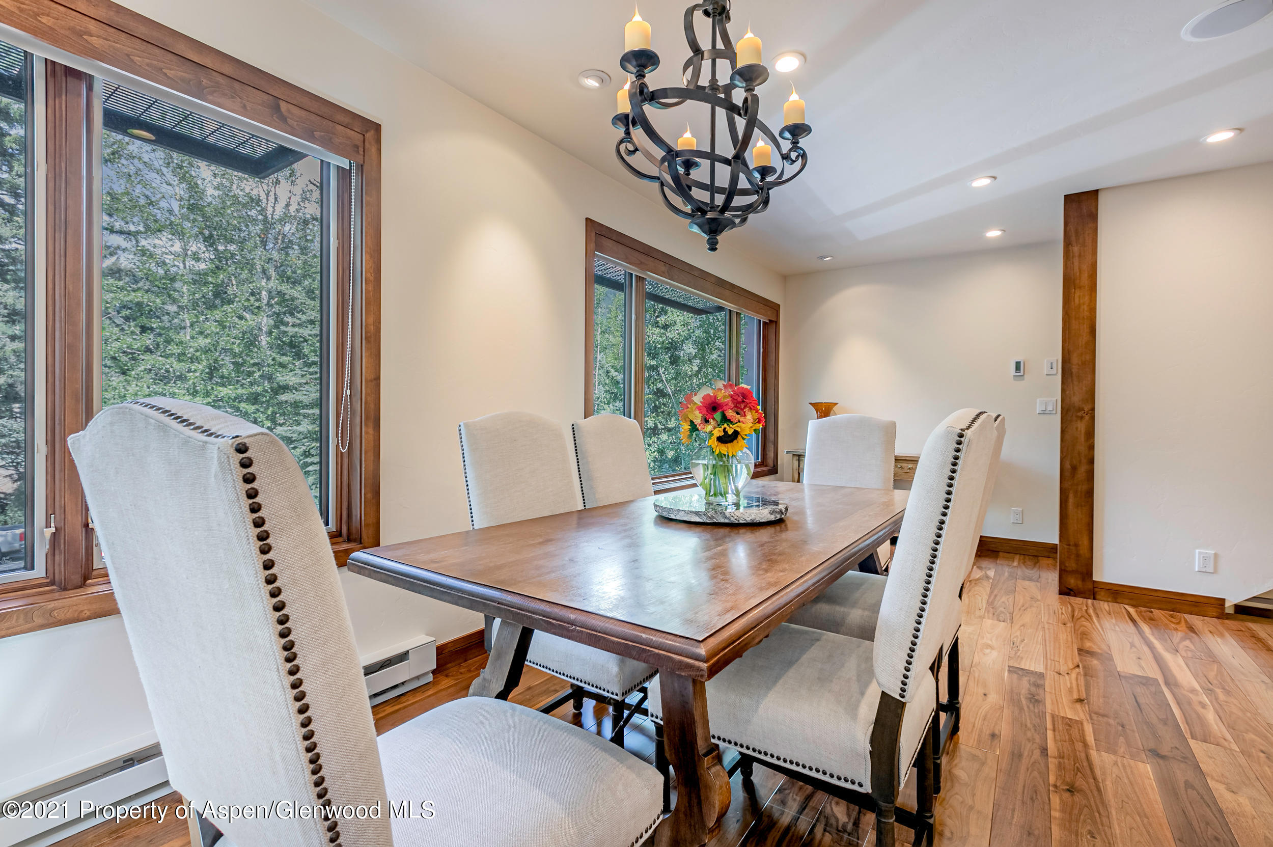 851 Ute Avenue, Unit A Aspen, CO 81611 - Photo 10 of 20 a view of a dining room with furniture window and wooden floor