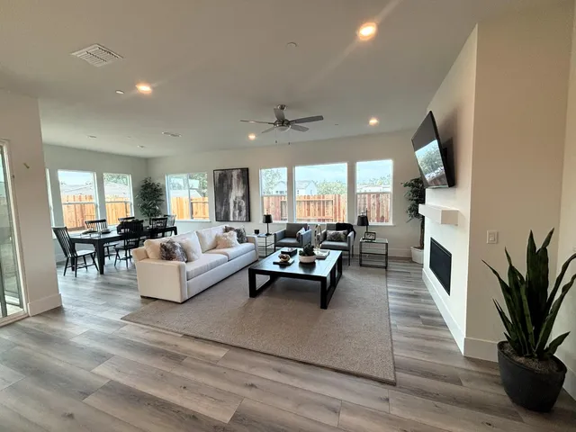 a living room with fireplace furniture and a flat screen tv