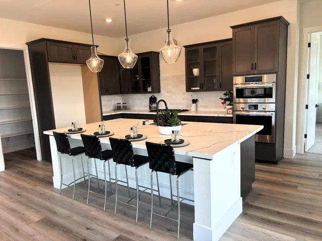 a large kitchen with a table and chairs