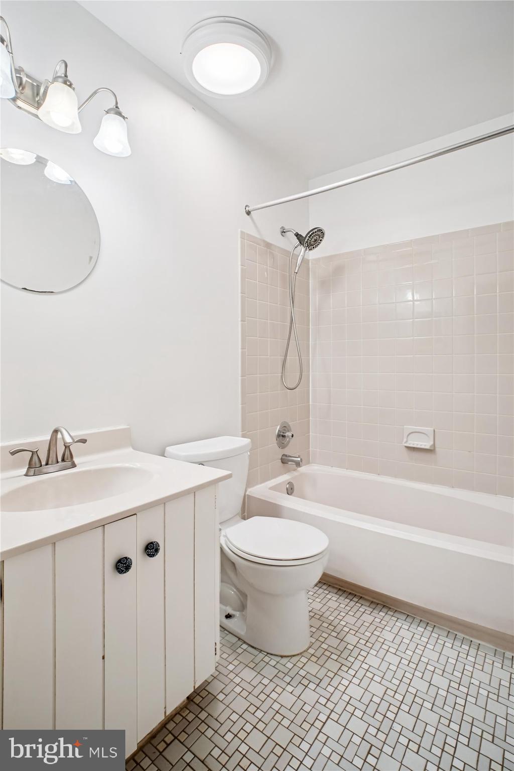 2816 Kelly Square Vienna, VA 22181 - Photo 32 of 73 a bathroom with a double vanity sink toilet mirror and shower