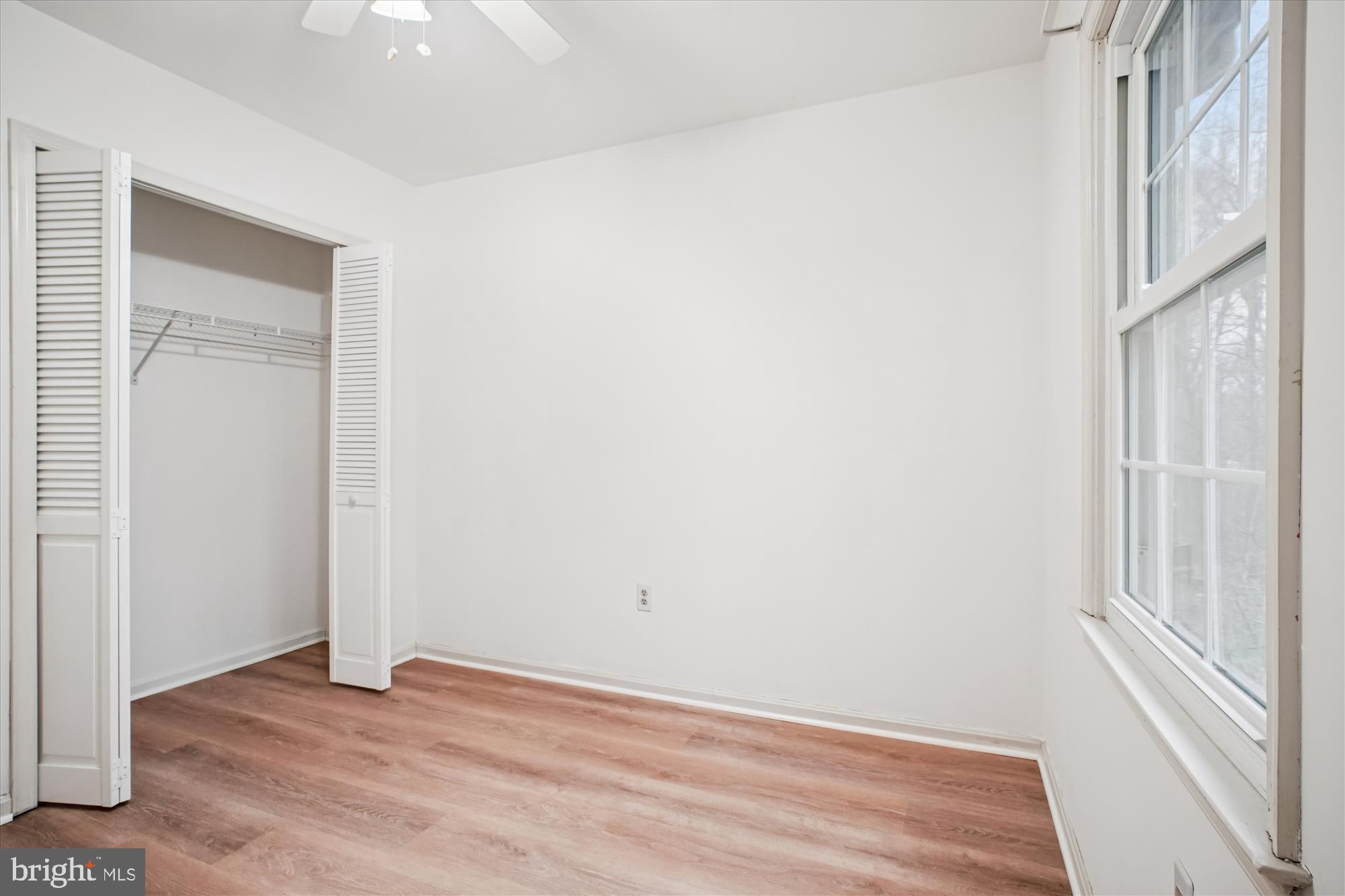 2816 Kelly Square Vienna, VA 22181 - Photo 42 of 73 a view of an empty room with wooden floor and a window