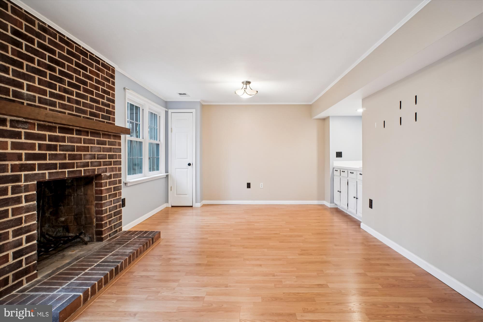 2816 Kelly Square Vienna, VA 22181 - Photo 51 of 73 a view of empty room with wooden floor and fireplace