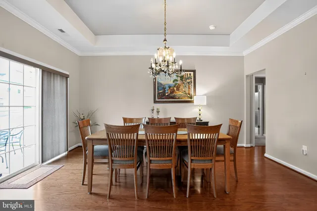 a view of a dining room with furniture wooden floor and chandelier