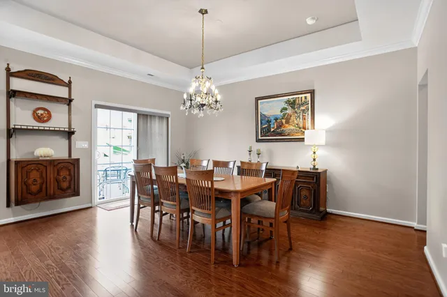 a view of a dining room with furniture wooden floor and chandelier