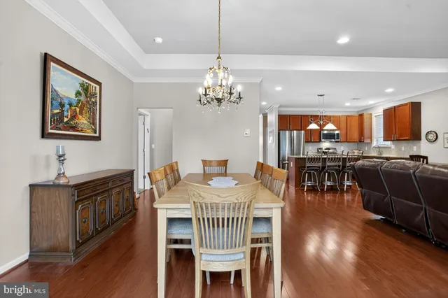 a view of a dining room with furniture wooden floor and chandelier