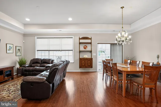 a living room with furniture a window and a chandelier