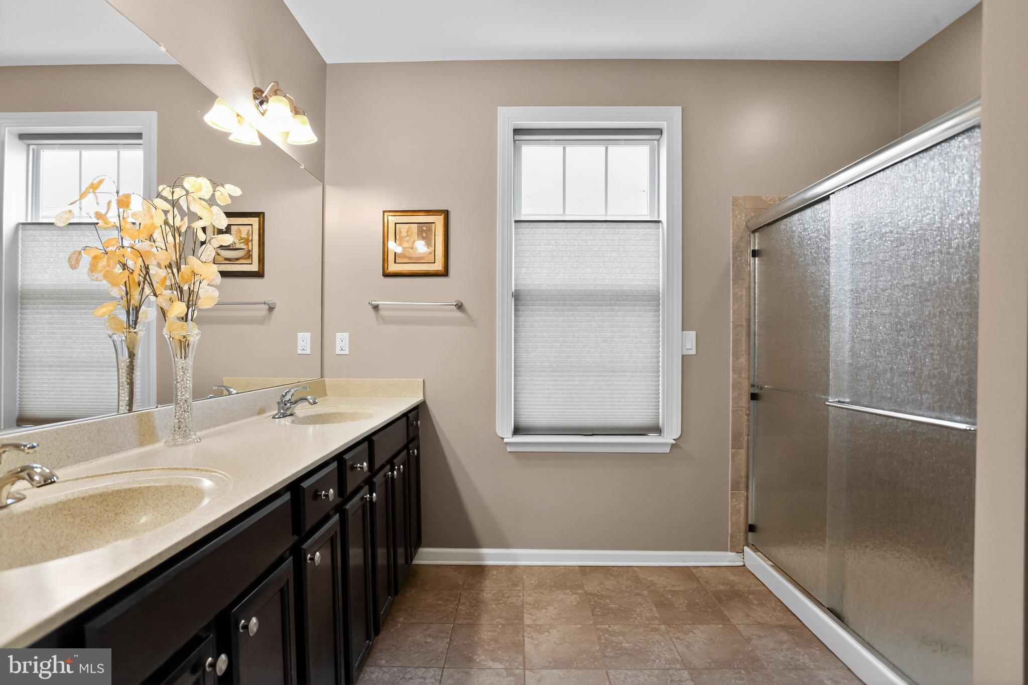 2680 Iris Lane Philadelphia, PA 19116 - Photo 23 of 30 a bathroom with a granite countertop sink a mirror and a shower
