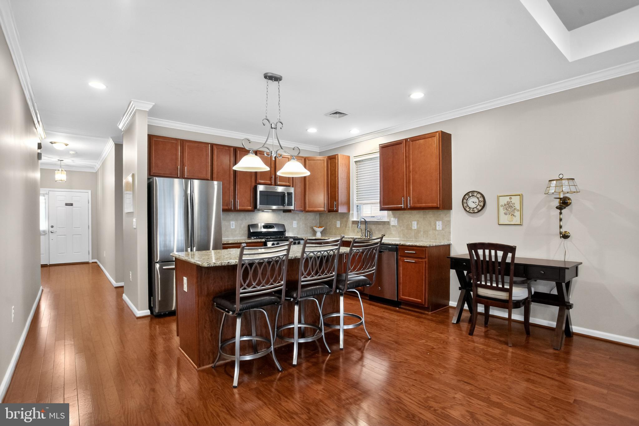 2680 Iris Lane Philadelphia, PA 19116 - Photo 6 of 30 a kitchen with stainless steel appliances a dining table chairs stove and wooden floor