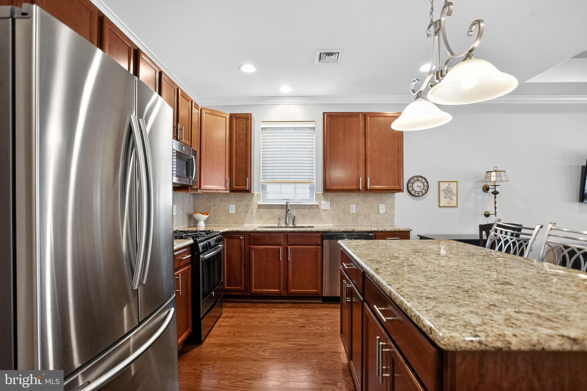 2680 Iris Lane Philadelphia, PA 19116 - Photo 10 of 30 a kitchen with stainless steel appliances granite countertop a sink stove and refrigerator