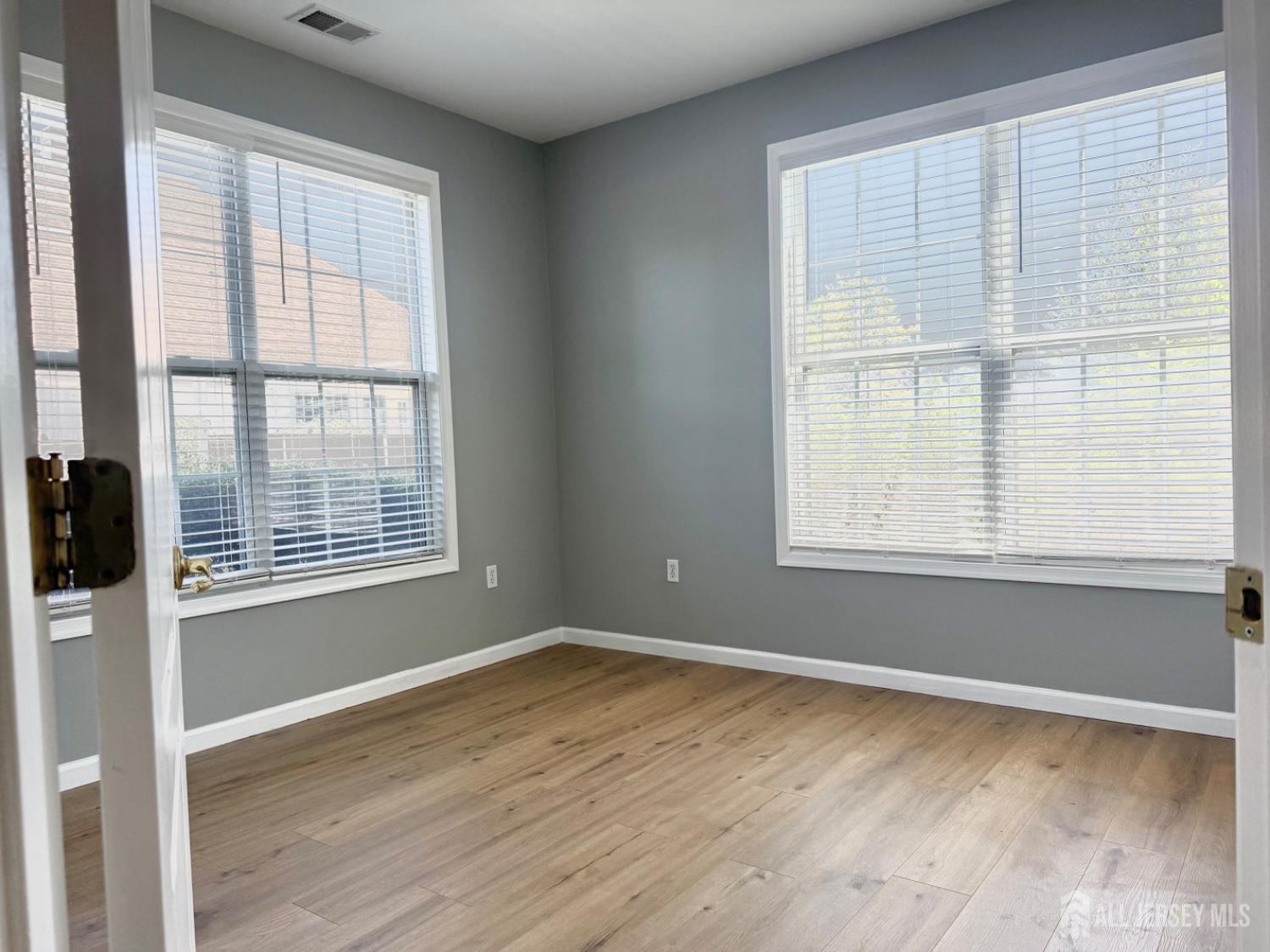 3213 Edward Stec Boulevard Edison, NJ 08837 - Photo 11 of 30 a view of an empty room with wooden floor and a window