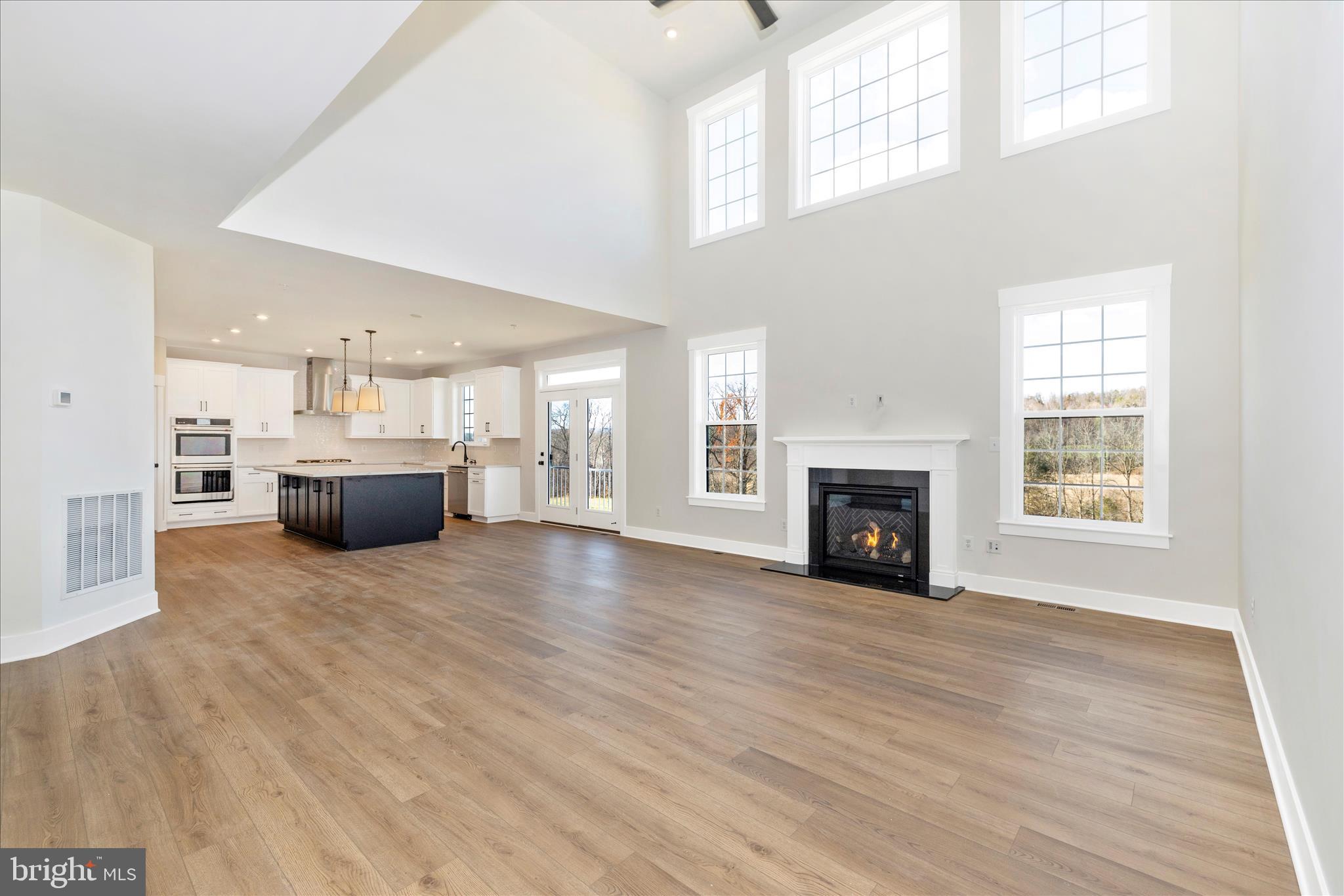 10242 Daysville Road Walkersville, MD 21793 - Photo 15 of 44 a view of kitchen and empty room with wooden floor