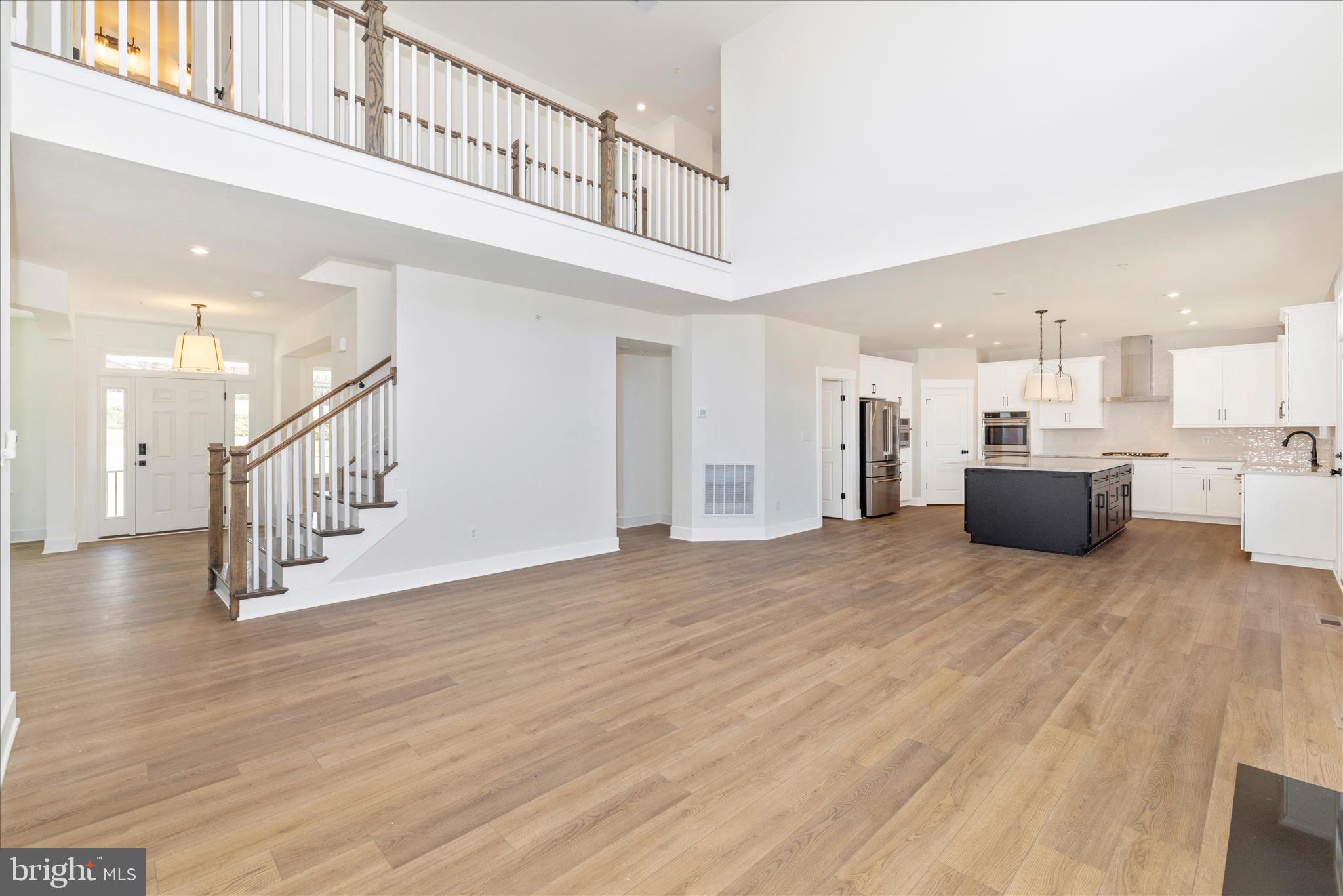 10242 Daysville Road Walkersville, MD 21793 - Photo 16 of 44 a view of a big room with wooden floor and a kitchen