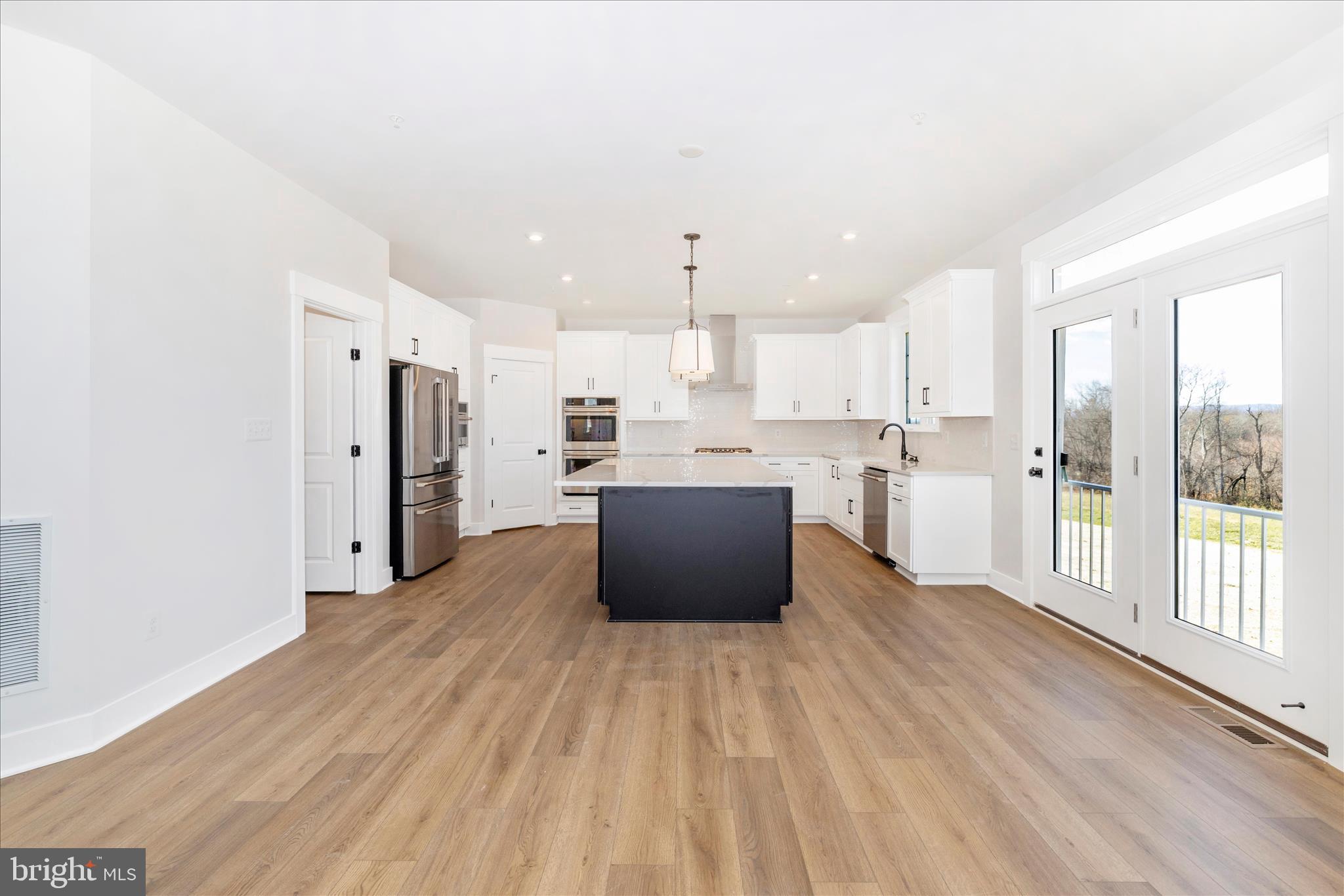 10242 Daysville Road Walkersville, MD 21793 - Photo 17 of 44 a large white kitchen with a refrigerator a stove top oven a sink and a large window