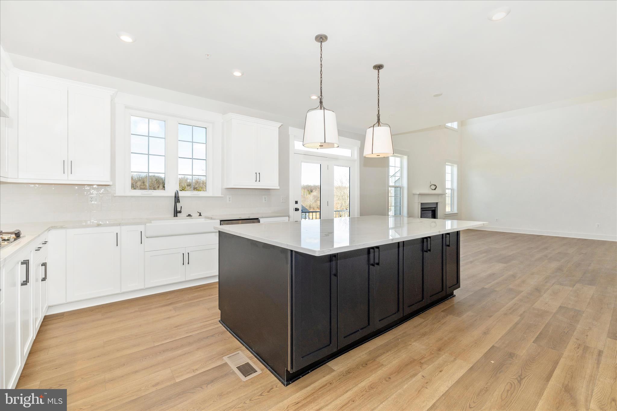 10242 Daysville Road Walkersville, MD 21793 - Photo 21 of 44 a kitchen with kitchen island granite countertop a sink counter top space and stainless steel appliances