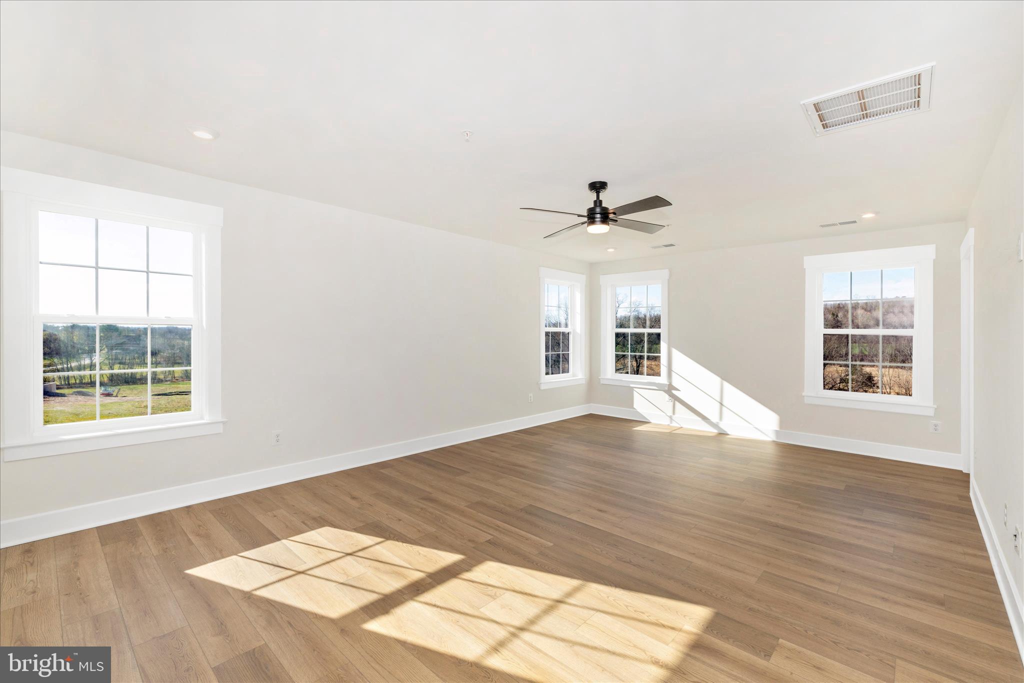 10242 Daysville Road Walkersville, MD 21793 - Photo 23 of 44 a view of empty room with wooden floor and fan