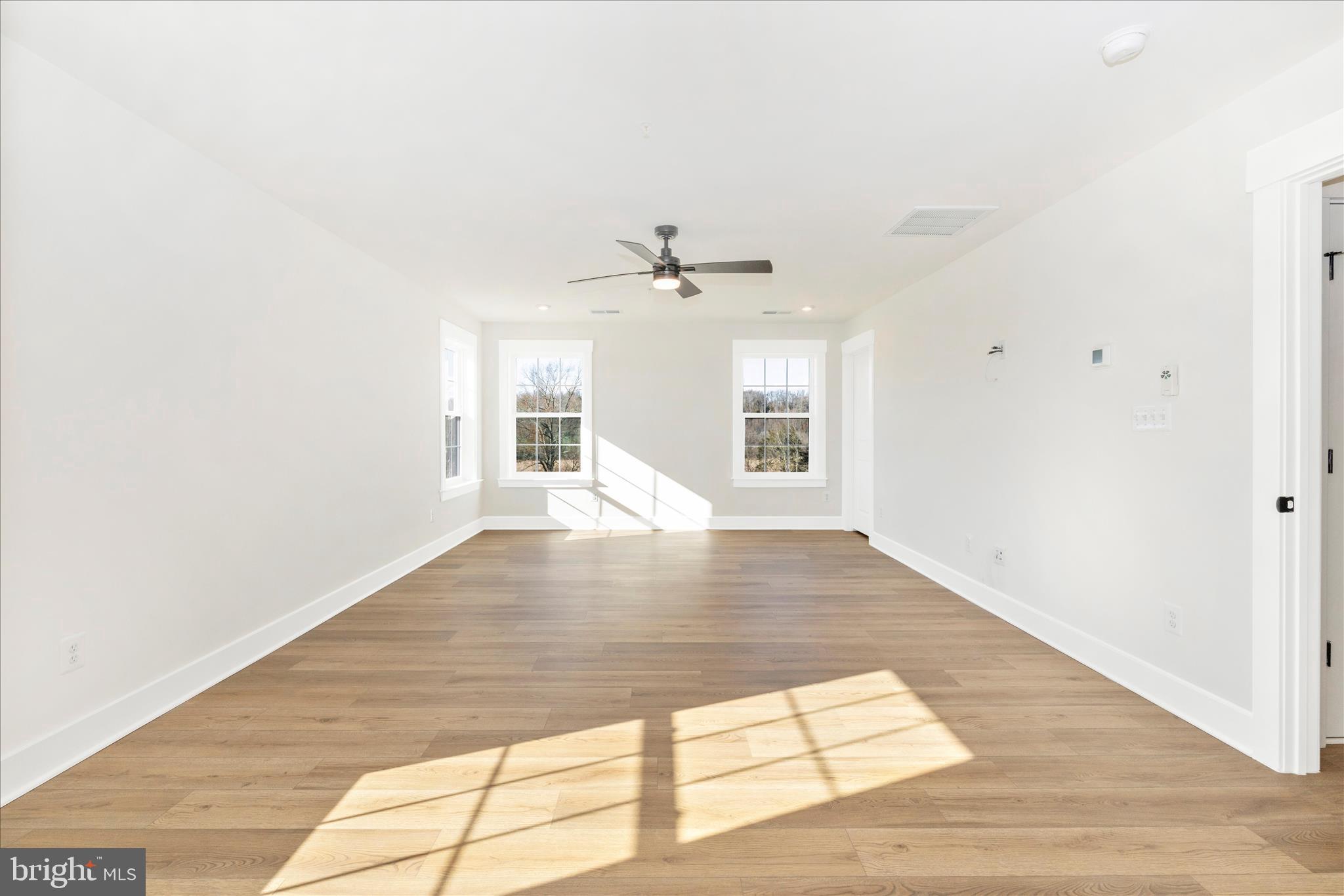 10242 Daysville Road Walkersville, MD 21793 - Photo 24 of 44 a view of an empty room with wooden floor and a window