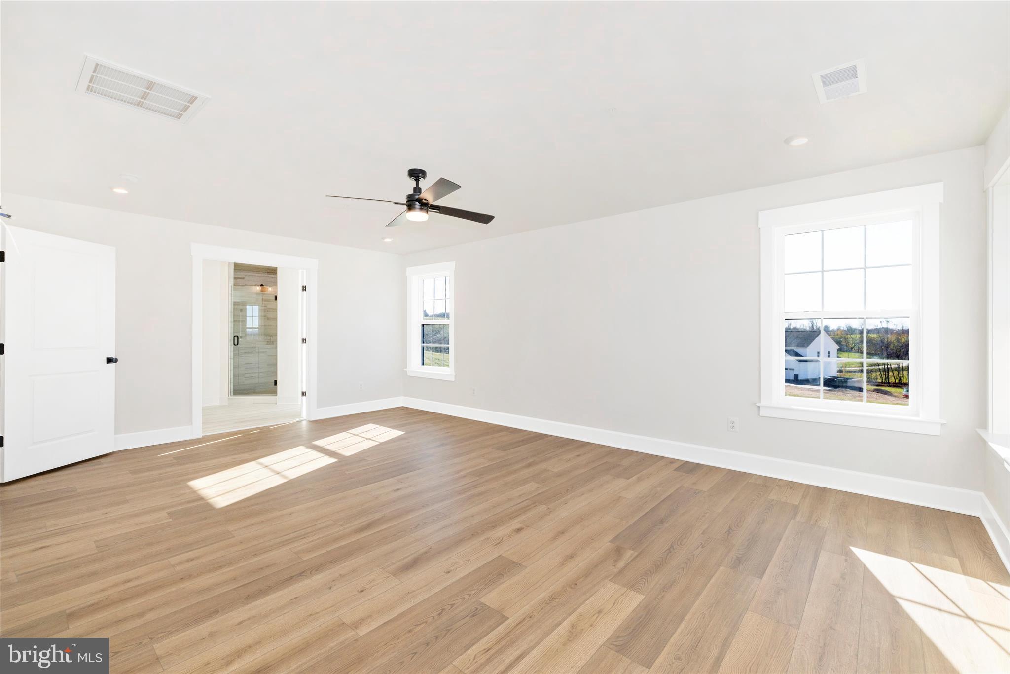 10242 Daysville Road Walkersville, MD 21793 - Photo 26 of 44 a view of an empty room with wooden floor and a window