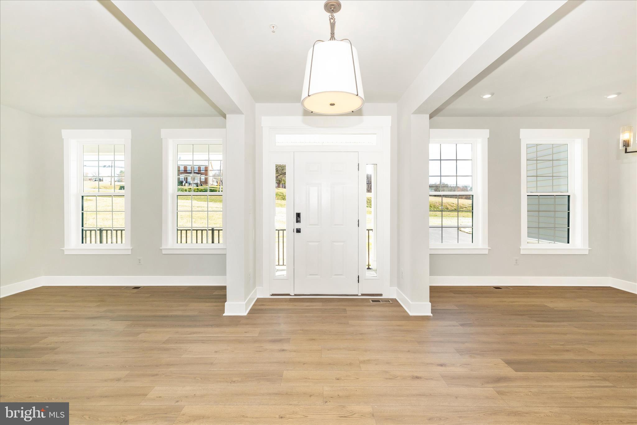 10242 Daysville Road Walkersville, MD 21793 - Photo 5 of 44 an empty room with wooden floor and windows