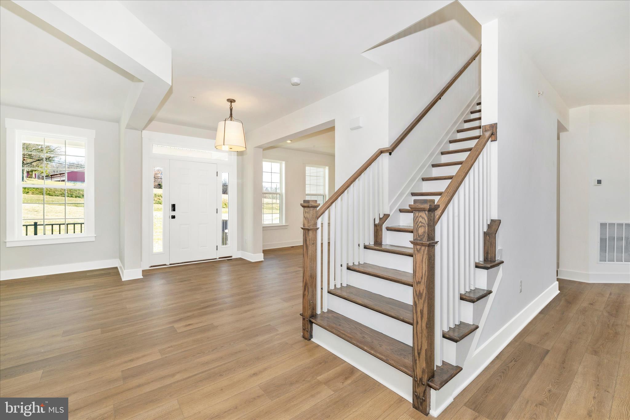 10242 Daysville Road Walkersville, MD 21793 - Photo 6 of 44 a view of entryway with wooden floor and stairs