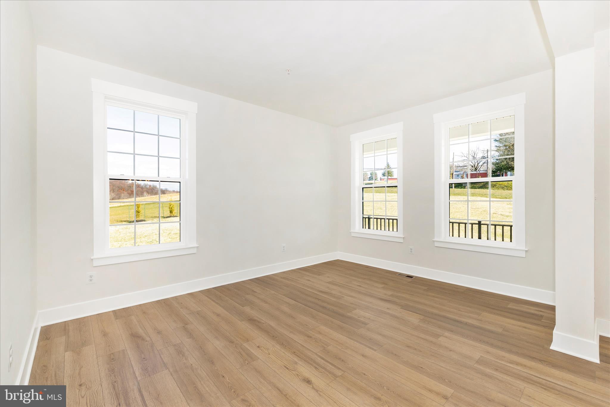 10242 Daysville Road Walkersville, MD 21793 - Photo 8 of 44 an empty room with wooden floor and windows