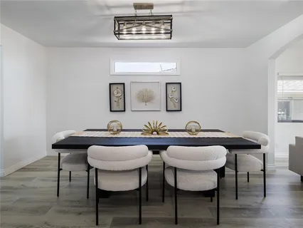 a view of a dining room with furniture and wooden floor