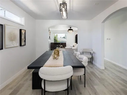 a living room with furniture kitchen and a chandelier