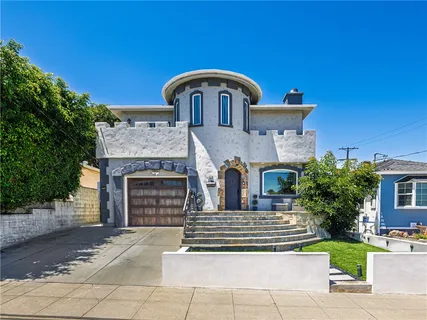 a front view of a house with a garden
